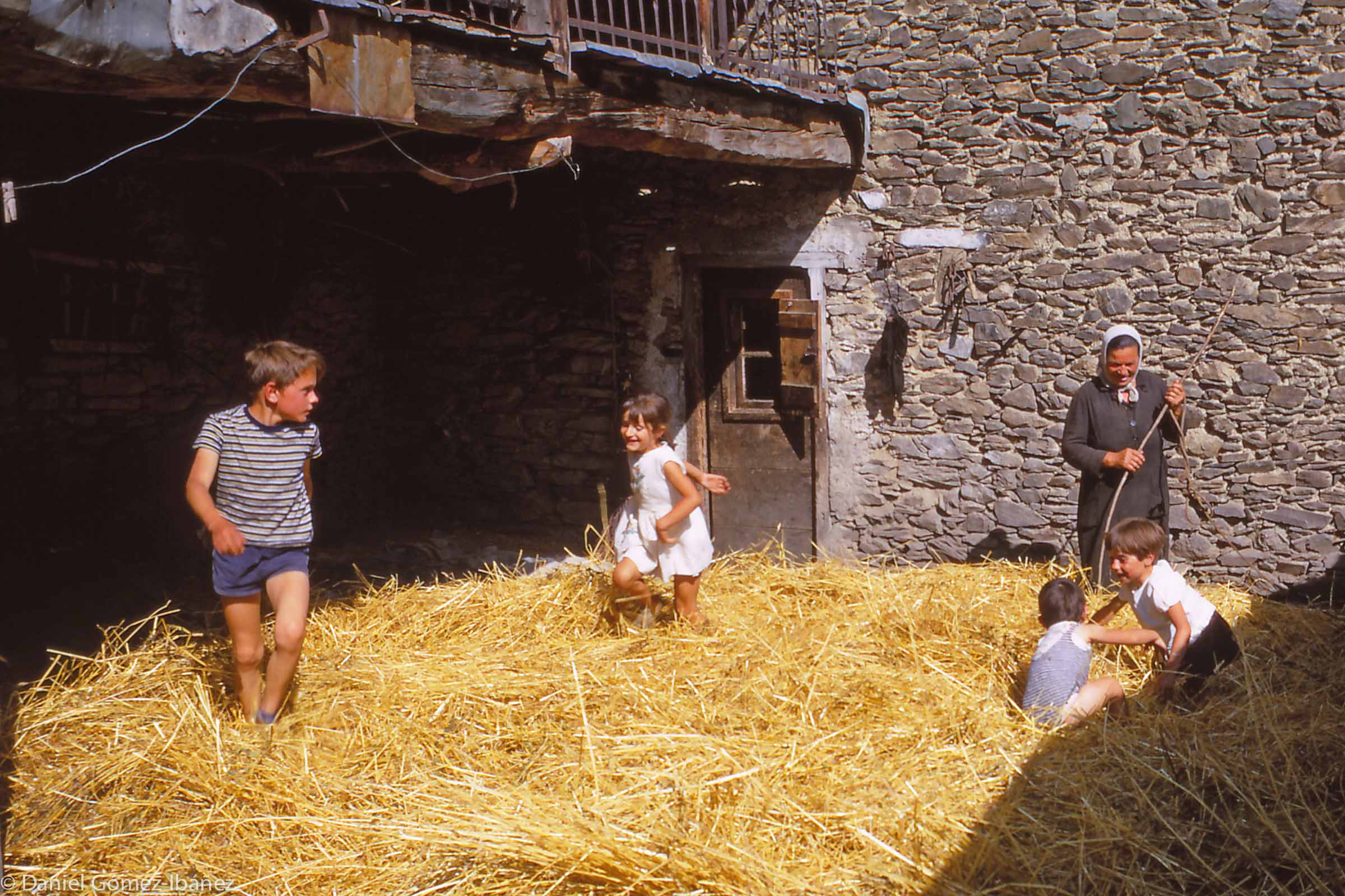 Village children romp in the straw. Pepita (center) is the Monge's granddaughter.